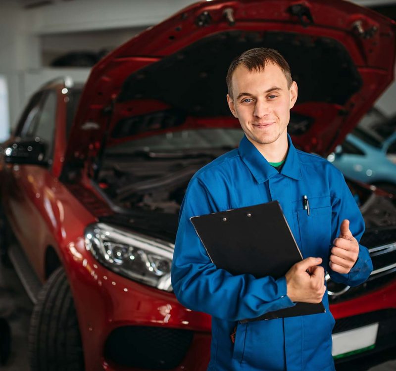 technician-with-notebook-car-with-opened-hood-small.jpg